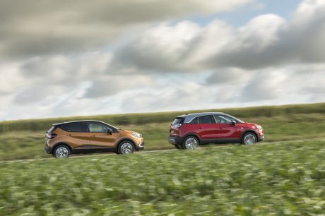 Renault Captur orange et opel Crossland X rouge se suivant sur une route vue de profil