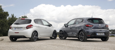 Renault Clio 2016 grise garée à côté d'une Peugeot 208 GT Line blanche vue arrière
